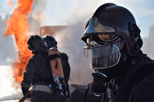 istock Firefighter extinguishing a traffic accident fire 1440018265