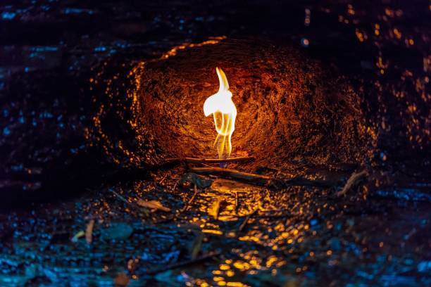 istock Bonfire in a cave surrounded by rocks and branches during the rain 1440018274