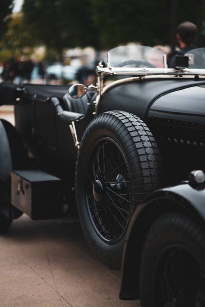 istock Low angle vertical shot of a black antique automobile - great for an article about retro vehicles 1440019216