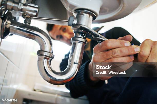 Closeup Of Plumber Repairing Sink With Tool In Bathroom Stock Photo - Download Image Now