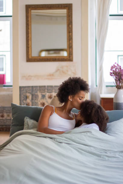 istock Tender mother and daughter in bed 1440021017