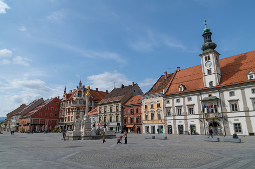 Main square (Glavni trg) in historic center of Maribor after renovation in 2021. In the centre of the square stands the Plague Column, Maribor, Slovenia