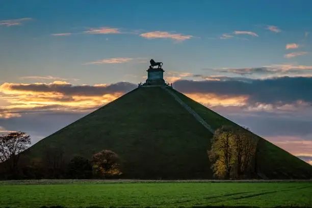 Photo of Lion's Mound on a high grassy hill in Belgium under the breathtaking sky