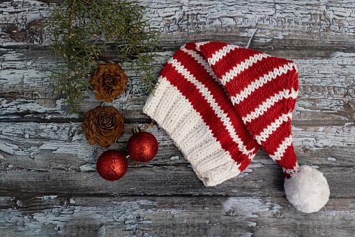 Christmas elf hats knitted with wool on rustic wood