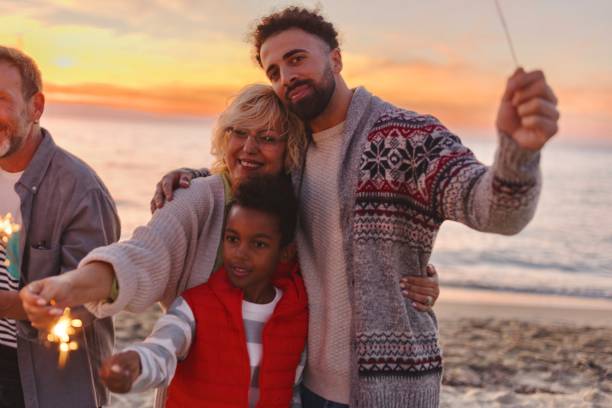 istock Multi-generation family celebrating Christmas on the beach 1440023092