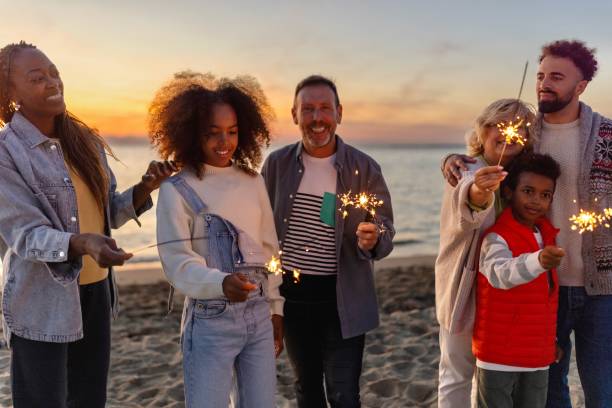 istock Multi-generation family celebrating Christmas on the beach 1440023156