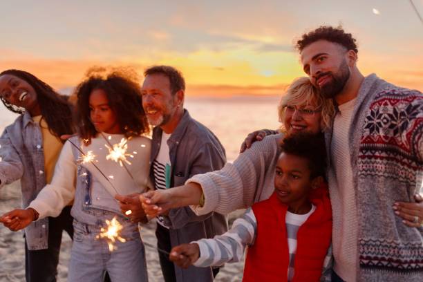 istock Multi-generation family celebrating Christmas on the beach 1440023165