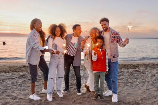 istock Multi-generation family celebrating Christmas on the beach 1440023727