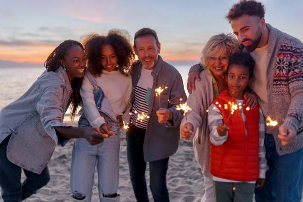 istock Multi-generation family celebrating Christmas on the beach 1440023730