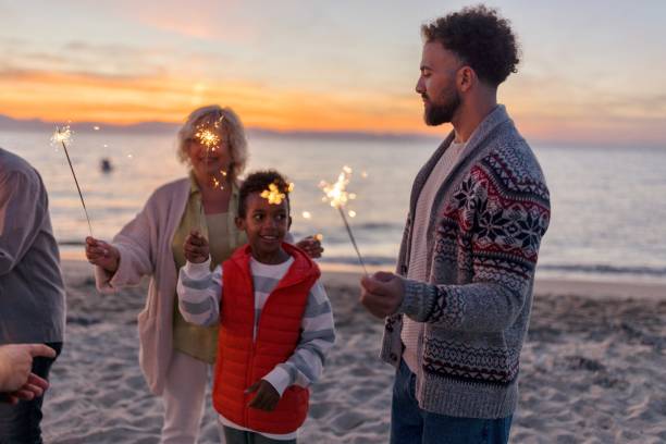 istock Multi-generation family celebrating Christmas on the beach 1440023772