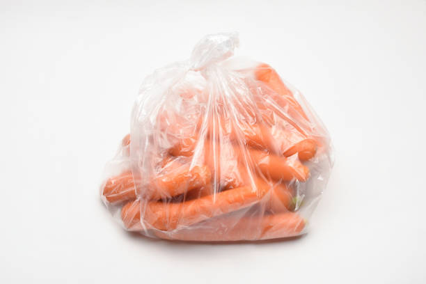 istock Carrots in a plastic bag on the white background 1440023802