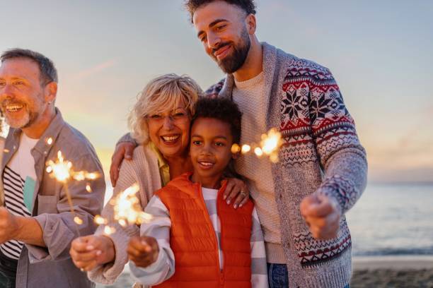 Multi-generation family celebrating Christmas on the beach