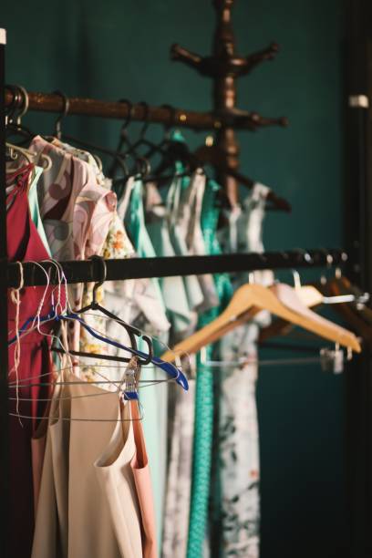 istock Vertical selective shot of brown clothes hangers hanged on a rack with clothes 1440024421