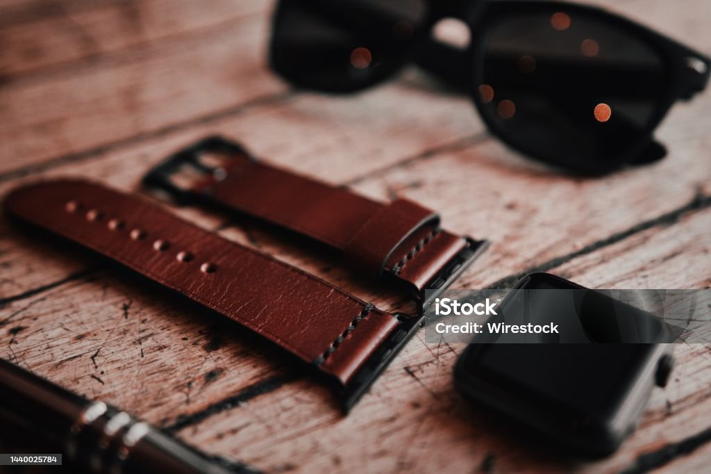 Closeup of a black bezel smartwatch and a brown leather strap A closeup of a black bezel smartwatch and a brown leather strap Active Lifestyle Stock Photo