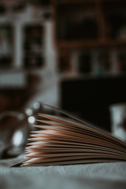 istock Vertical close up shot of open book pages with blurred background 1440026415