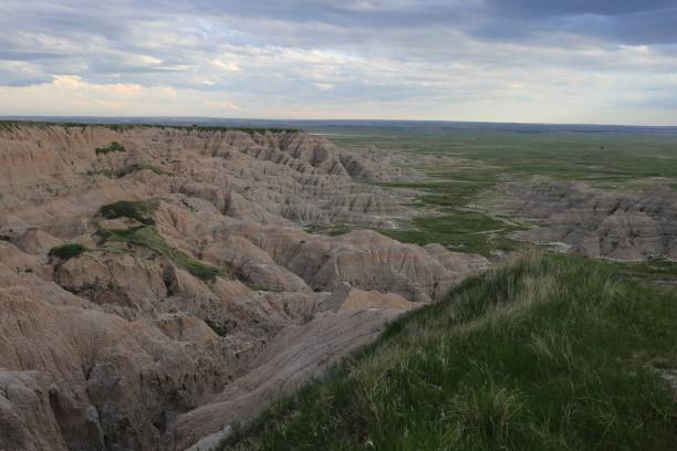 istock Aerial shot of badlands with grassy fields 1440026695