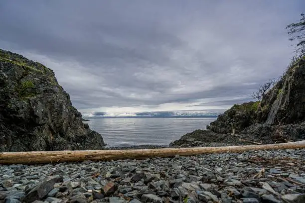 Photo of Beautiful shot of rocky hills on the seashore under a clear sky