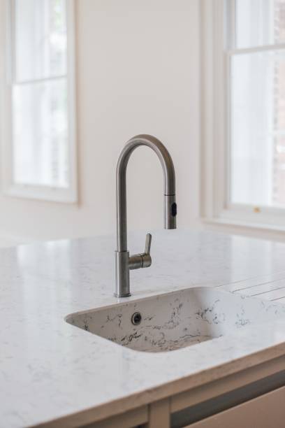 istock Vertical shot of a white sink in the kitchen 1440028573