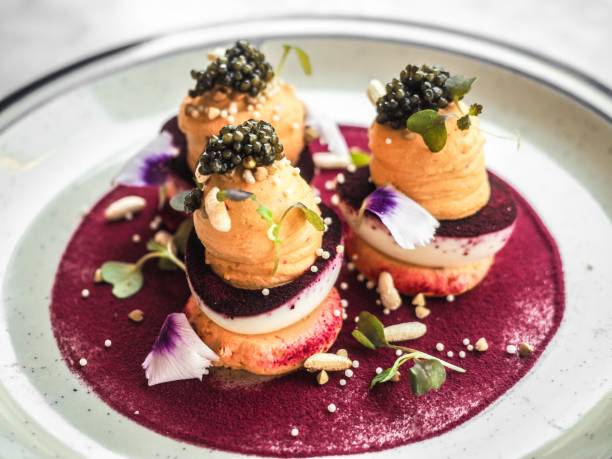 istock Closeup shot of deviled eggs with caviar on top on a biscuit in a round white plate 1440028883