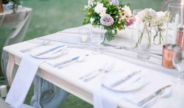 istock Beautiful outdoor table setting with floral decorations and candles for a wedding reception 1440030021