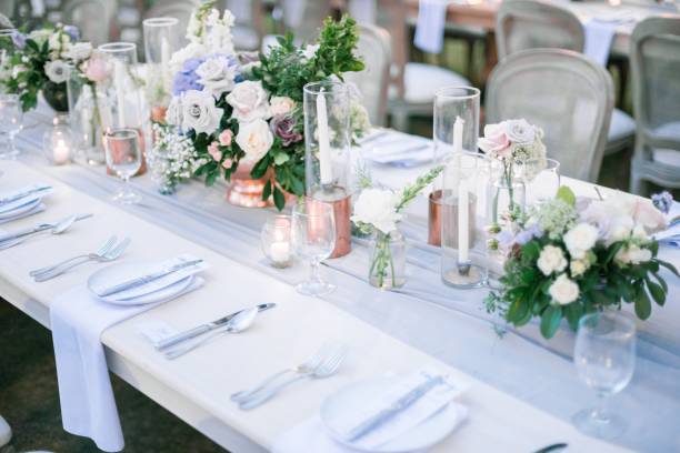istock Beautiful outdoor table setting with floral decorations and candles for a wedding reception 1440030024