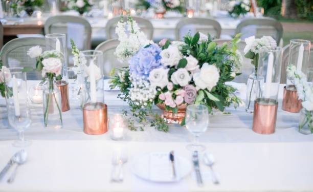 istock Beautiful outdoor table setting with floral decorations and candles for a wedding reception 1440030029