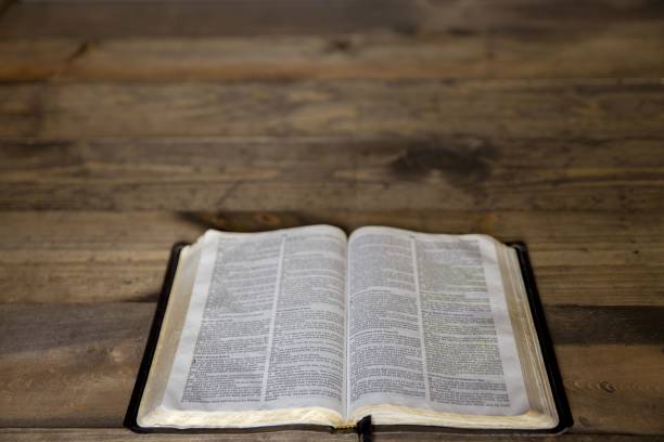 istock High angle shot of an open book on a wooden surface with a blurred background 1440030178