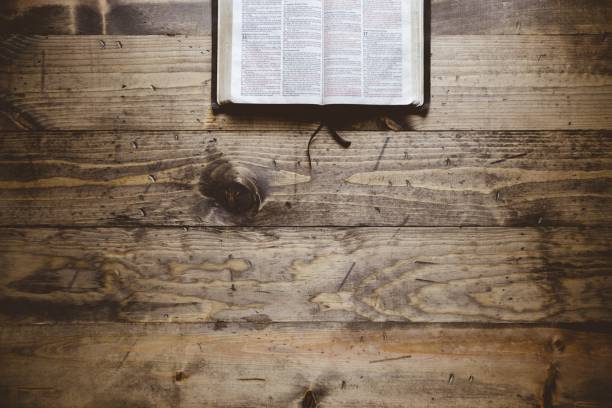 istock Overhead shot of an open book on a wooden surface 1440030850