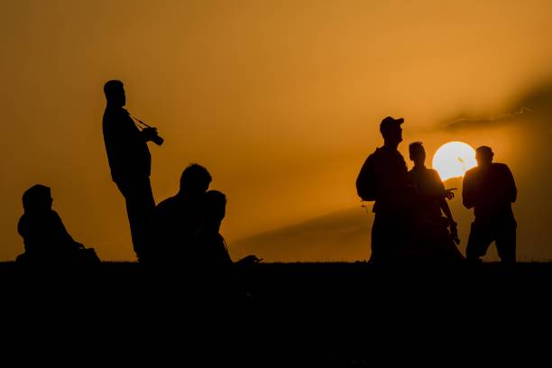 istock Horizontal shot of silhouetted people during the sunset 1440030985
