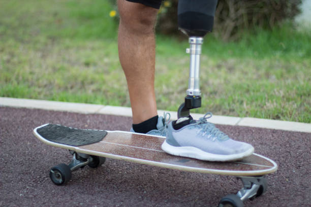istock Side view of person with disability on skateboard 1440031852