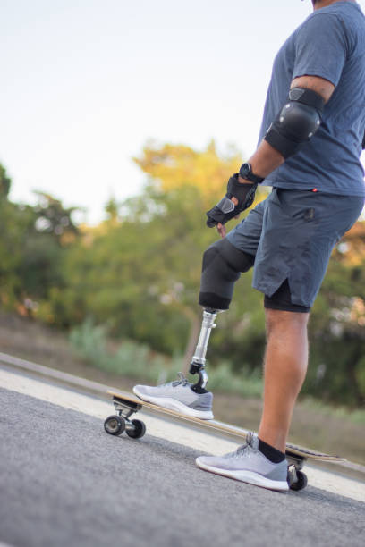 istock Side view of person with disability on skateboard 1440031854