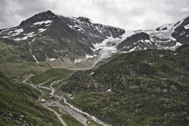 istock Mesmerizing scenery of the beautiful snow-capped mountains under a cloudy sky 1440032110