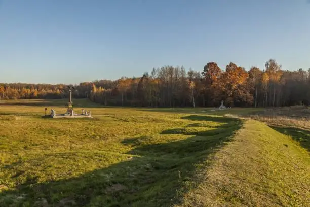 A horizontal shot of a stone monument in Borodino field, Russia during autumn surrounded by trees