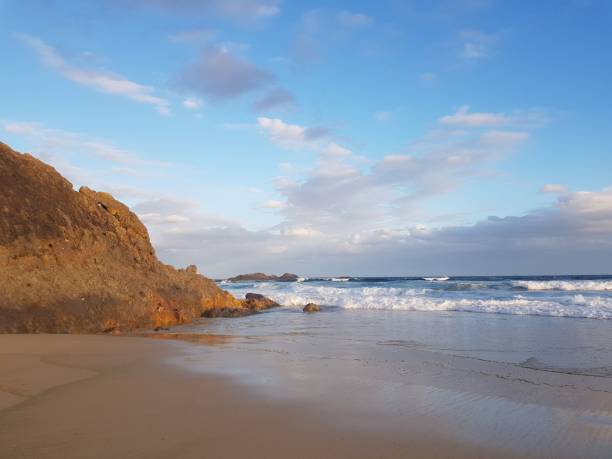 istock Seascape with a calm water and sandy beach under a blue sky 1440033016