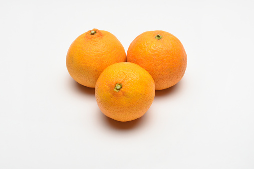 Group of fresh organic tangerines fruit on the white background