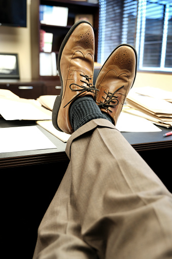 Business man businessman with feet up on desk relaxing