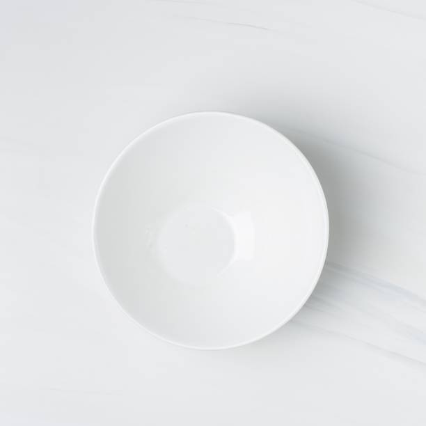 istock Closeup shot of an empty white ceramic bowl on a white background 1440035861