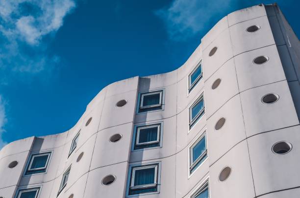 istock Low angle shot of an abstract white architectural building under a blue sky 1440035894