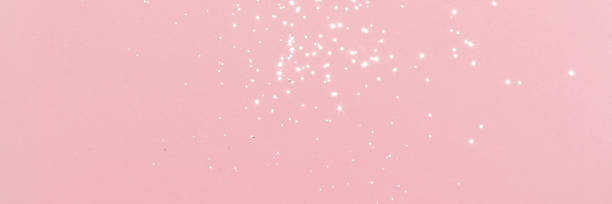 istock Sparkling silver glitter on pink background banner 1440036222