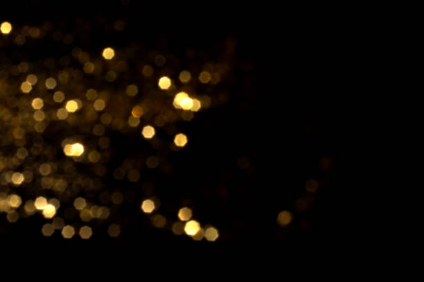 istock Golden blurred bokeh lights on black background 1440036263