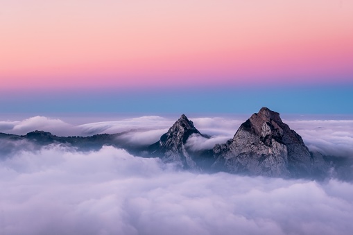 A beautiful aerial shot of Fronalpstock mountains in Switzerland under the beautiful pink and blue sky