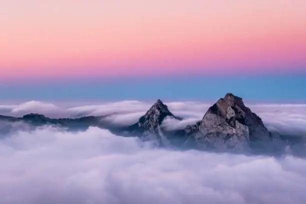 A beautiful aerial shot of Fronalpstock mountains in Switzerland under the beautiful pink and blue sky