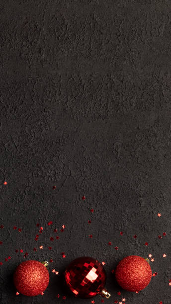 istock Christmas card with red balls on black background 1440036527
