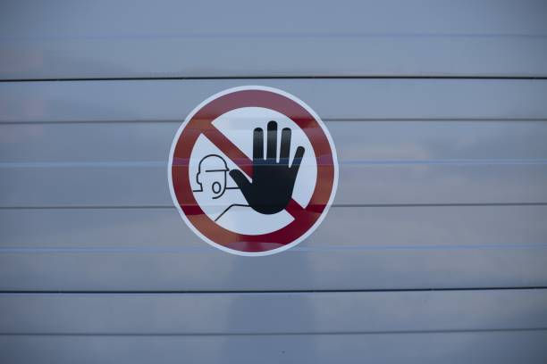 istock Sticker of a stop sign on a light blue wall in a construction site 1440037016