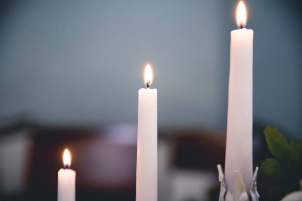 istock Selective focus closeup shot of lighted white candles 1440037320