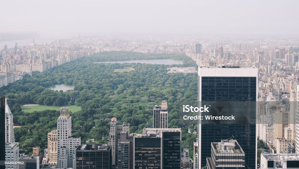 Aerial photo of Central Park with a lot of high-rise buildings and trees covered in fog An aerial photo of Central Park with a lot of high-rise buildings and trees covered in fog Above Stock Photo