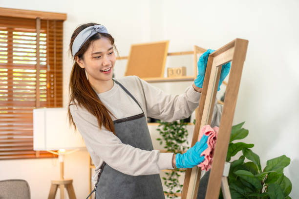 istock Housekeeper is wearing protective gloves and using microfiber cloth to cleanups and wiping dirt on the glass 1440038528