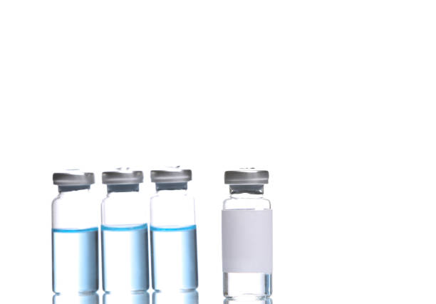 istock Vaccine bottles with blue liquid and bottle with blank label  isolated on white background with reflection 1440038695