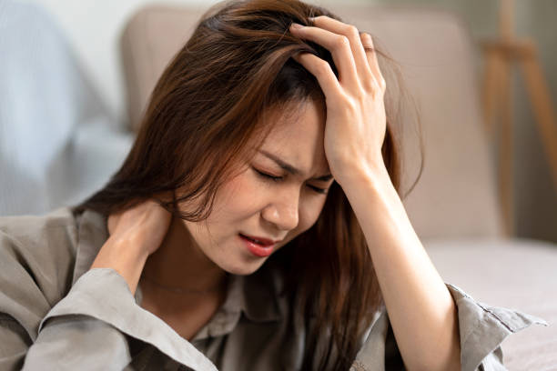 istock Female employee sitting on the floor to touching forehead and the neck while feeling stressed and disappointed 1440038983