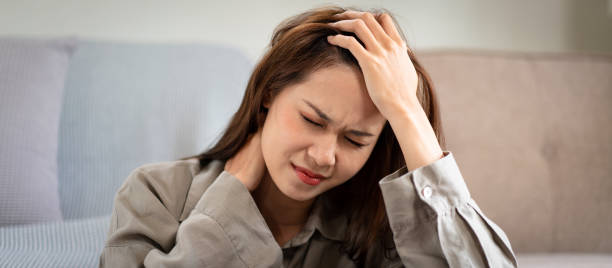 istock Female employee sitting on the floor to touching forehead and the neck while feeling stressed and disappointed 1440038986